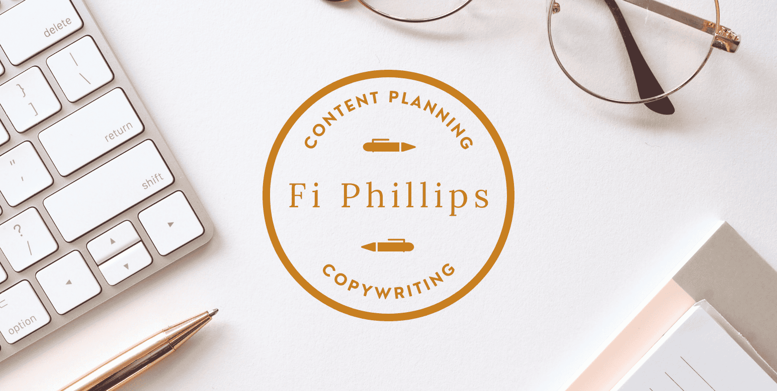 desk with pen, pad, pair of glasses, keyboard and Fi Phillips Copywriter logo